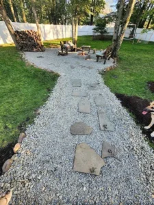 Local hardscaping materials including bluestone and river rock in a natural setting