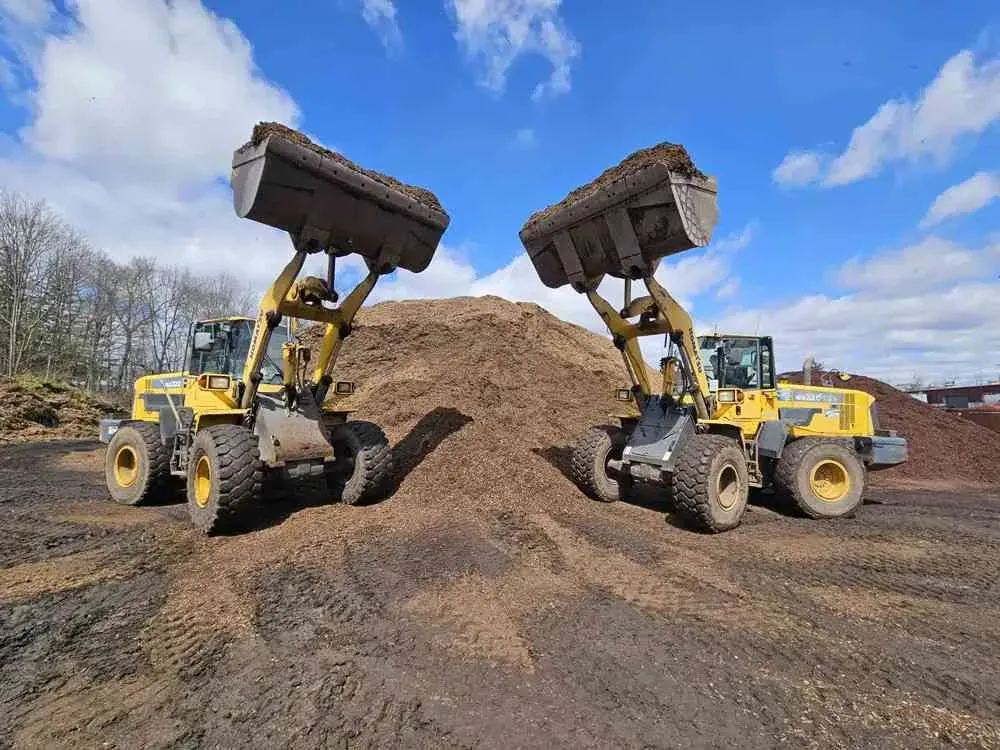 Delivery of bulk landscaping materials at a residential site, showcasing logistics and teamwork